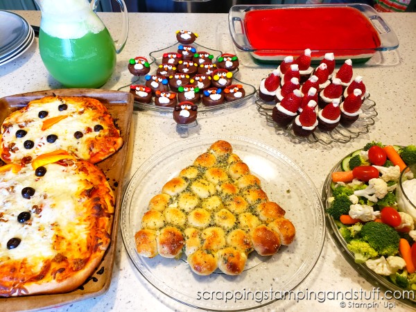 Take a look at our fun food Christmas celebration featuring snowman pizza, Christmas tree bread, a wreath relish tray, santa hat brownies, penguin oreos and Grinch punch!