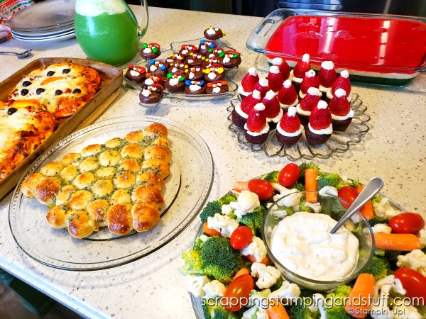 Take a look at our fun food Christmas celebration featuring snowman pizza, Christmas tree bread, a wreath relish tray, santa hat brownies, penguin oreos and Grinch punch!